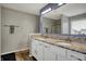 Bright bathroom with a large mirror, double vanity with white cabinets, and granite countertops at 7736 Eagle Point Cir, Zionsville, IN 46077