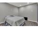 Bedroom with gray walls and plank flooring, nicely staged with a comfy queen-size bed at 7736 Eagle Point Cir, Zionsville, IN 46077