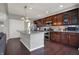 A spacious kitchen boasts a large island with granite countertops and stainless steel appliances at 7736 Eagle Point Cir, Zionsville, IN 46077