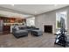 Bright, open living space with a fireplace, hardwood floors, and a gray sofa at 7736 Eagle Point Cir, Zionsville, IN 46077