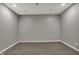Empty room featuring gray walls, pot lights, and gray plank flooring at 7736 Eagle Point Cir, Zionsville, IN 46077
