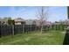 Spacious backyard featuring grass, partial privacy fencing, and plenty of room for outdoor activities at 8142 Bentley Farms Dr, Indianapolis, IN 46259