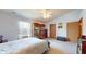 Spacious bedroom with display cabinets, ceiling fan, and a neutral color scheme, offering a relaxing retreat at 8142 Bentley Farms Dr, Indianapolis, IN 46259