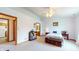 Bright bedroom featuring neutral decor, a ceiling fan, and doorway to a bathroom, providing a restful space at 8142 Bentley Farms Dr, Indianapolis, IN 46259