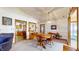 Bright dining area with a wooden table set for four, seamlessly connected to the kitchen and living room at 8142 Bentley Farms Dr, Indianapolis, IN 46259
