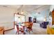 Open dining area with ample natural light, wooden table, and seamless flow into the living space at 8142 Bentley Farms Dr, Indianapolis, IN 46259