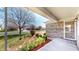 Inviting front porch with flowering plants and a view of the neighborhood at 8142 Bentley Farms Dr, Indianapolis, IN 46259