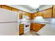 Functional kitchen featuring oak cabinets, white appliances, and ample counter space for meal preparation at 8142 Bentley Farms Dr, Indianapolis, IN 46259