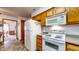 Efficient kitchen with white appliances and oak cabinets, providing a practical space for cooking at 8142 Bentley Farms Dr, Indianapolis, IN 46259