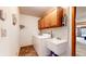Laundry room featuring a washer, dryer, utility sink, and storage cabinets at 8142 Bentley Farms Dr, Indianapolis, IN 46259