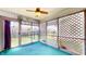 Bright sunroom with lattice screens, a ceiling fan, and views of the fenced backyard, perfect for relaxation at 8142 Bentley Farms Dr, Indianapolis, IN 46259