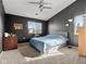 This bedroom features a ceiling fan, a window, and a carpeted floor at 8810 Yardley Ct # 208, Indianapolis, IN 46268