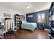 This bedroom includes a bed, bookshelf, desk, and a window at 8810 Yardley Ct # 208, Indianapolis, IN 46268