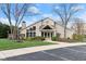 The clubhouse features a well-manicured lawn and landscaping with beautiful trees at 8810 Yardley Ct # 208, Indianapolis, IN 46268