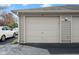 This is a garage with a white door and a car parked in the driveway at 8810 Yardley Ct # 208, Indianapolis, IN 46268