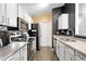 Modern kitchen features stainless steel appliances, white cabinets, and granite countertops at 8810 Yardley Ct # 208, Indianapolis, IN 46268