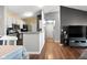 Open concept living room with hardwood floors flows into a well-equipped kitchen at 8810 Yardley Ct # 208, Indianapolis, IN 46268