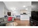 Open concept living room with hardwood floors flows into a dining area and kitchen at 8810 Yardley Ct # 208, Indianapolis, IN 46268