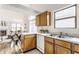 Bright kitchen view of wood cabinets, white appliances, and lots of counter space in an open concept at 9223 Steeplechase Dr, Indianapolis, IN 46250