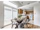 Bright eat-in kitchen with glass table, stainless chairs, and slider door to the outside patio at 9223 Steeplechase Dr, Indianapolis, IN 46250
