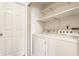 Bright laundry area with a side-by-side washer and dryer, and ample storage shelves at 9223 Steeplechase Dr, Indianapolis, IN 46250