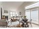 Open concept living and dining room with fireplace, white sofa, hardwood floors, and lots of light at 9223 Steeplechase Dr, Indianapolis, IN 46250