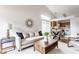 Open concept living space featuring a modern sofa and an adjacent dining and kitchen area at 9223 Steeplechase Dr, Indianapolis, IN 46250