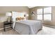 A well-lit main bedroom with a large bed, soft lamps, and a big sunny window at 9223 Steeplechase Dr, Indianapolis, IN 46250