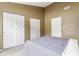 Well-lit bedroom with a queen sized bed, neutral walls, and double sliding door closet at 9223 Steeplechase Dr, Indianapolis, IN 46250