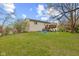 Spacious backyard featuring a wooden deck and mature trees, perfect for outdoor enjoyment at 9448 Burrwood Cir, Indianapolis, IN 46235