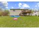 Lush backyard view with a wooden deck and plenty of open space at 9448 Burrwood Cir, Indianapolis, IN 46235