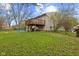Home exterior featuring a wooden deck and a spacious backyard at 9448 Burrwood Cir, Indianapolis, IN 46235