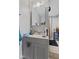 The bathroom has gray walls, a grey sink, and a large vanity mirror at 9448 Burrwood Cir, Indianapolis, IN 46235