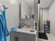 The bathroom has gray walls, a grey sink, and a large vanity mirror at 9448 Burrwood Cir, Indianapolis, IN 46235