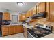 Well-maintained kitchen featuring tile backsplash, wooden cabinetry, and modern appliances at 9448 Burrwood Cir, Indianapolis, IN 46235