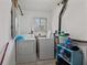The laundry room contains a washer and dryer, shelving, and a window at 9448 Burrwood Cir, Indianapolis, IN 46235