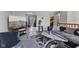 Open-concept living room leading to outdoor patio and kitchen area, perfect for entertaining at 9448 Burrwood Cir, Indianapolis, IN 46235