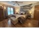 Cozy bedroom featuring a decorative wood accent wall, ceiling fan, and hardwood floors at 1066 Woodridge, Brownsburg, IN 46112