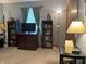 Bedroom featuring bookshelves, a large tv, and a ceiling fan at 1066 Woodridge, Brownsburg, IN 46112