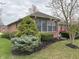 Well-maintained brick home with lush landscaping and mature trees at 1066 Woodridge, Brownsburg, IN 46112