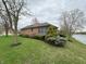 Charming brick home with manicured landscaping, green lawn, and a tranquil water view at 1066 Woodridge, Brownsburg, IN 46112