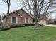 Brick home featuring mature trees, shutters, and an attached garage at 1066 Woodridge, Brownsburg, IN 46112