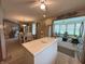 Open floor plan with kitchen island, dining area, and sunroom, ideal for entertaining at 1066 Woodridge, Brownsburg, IN 46112