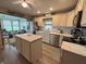 Bright kitchen featuring an island, stainless steel appliances, and connection to a sunroom at 1066 Woodridge, Brownsburg, IN 46112