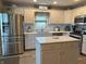 Well-lit kitchen featuring stainless steel appliances, central island, and ample cabinetry at 1066 Woodridge, Brownsburg, IN 46112