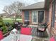 Relaxing outdoor patio with comfortable seating, brick exterior, and manicured landscaping at 1066 Woodridge, Brownsburg, IN 46112