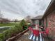 Inviting outdoor patio with pond views, stylish furniture, and brick exterior at 1066 Woodridge, Brownsburg, IN 46112
