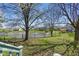 Spacious backyard with view of the pond, trees, and surrounding homes in a desirable community at 10875 Santa Anita Ct, Carmel, IN 46280