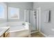 Bathroom boasts a shower and tub with natural light from two windows at 10875 Santa Anita Ct, Carmel, IN 46280