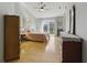 A well-lit bedroom with wood floors and a sliding glass door to a small balcony at 10875 Santa Anita Ct, Carmel, IN 46280